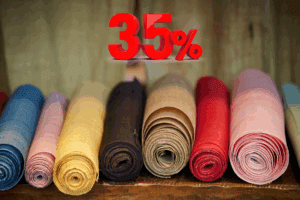 Rollos de tela de diversos colores y texturas con etiqueta de 35%, representando el nuevo arancel a importaciones textiles en México