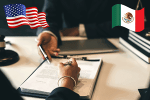 Dos personas estrechando manos frente a las banderas de México y Estados Unidos, simbolizando el inicio anticipado de la revisión del T-MEC.