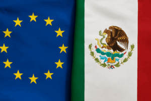 Banderas de México y la Unión Europea desplegadas una junto a la otra, mostrando sus símbolos distintivos